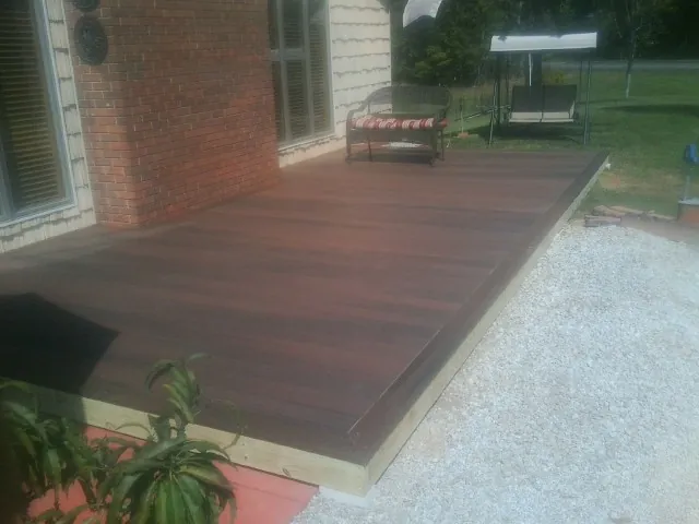Freshly stained wood deck built against a brick home in Estell Manor