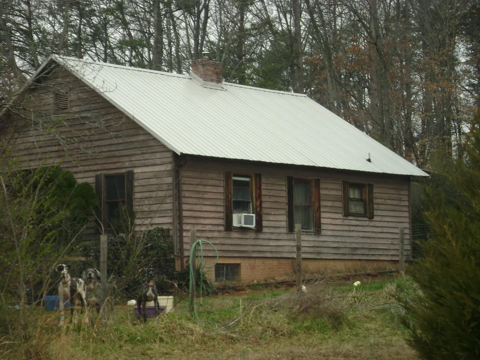 White metal roof on an old wood sided farmhouse, from a Metal Roof Installation job in Estell Manor